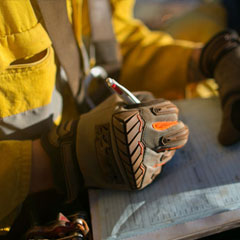 personnel wearing safety gloves while documenting